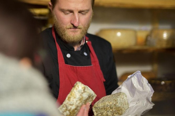 Paris Art of Pairing Cheese and Wine Tasting in a Cheese Cellar - A protective suit and a cellar full of cheese