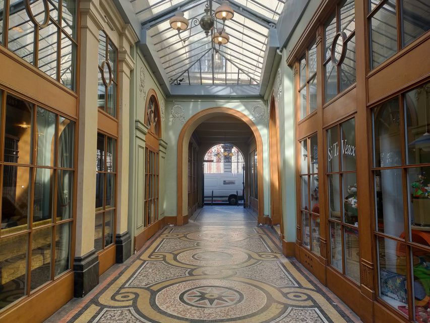 Paris: Covered Passages Walking Tour - Passage Jouffroy: glass, iron, and a wax museum