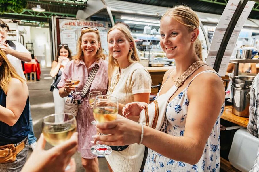 Paris: Walking Food Tour with Cheese, Wine and Delicacies - Charcuterie, hams, and the restaurant stop
