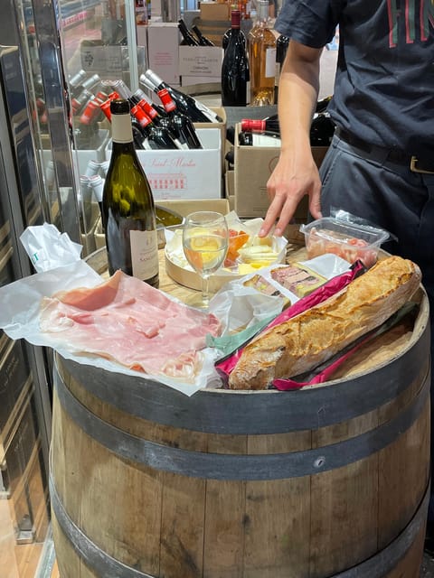 Versailles: Local & small-group Farmers' Market Food Tour - Choosing charcuterie and watching the cheese platter take shape